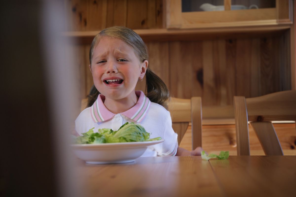 girl crying at the table.